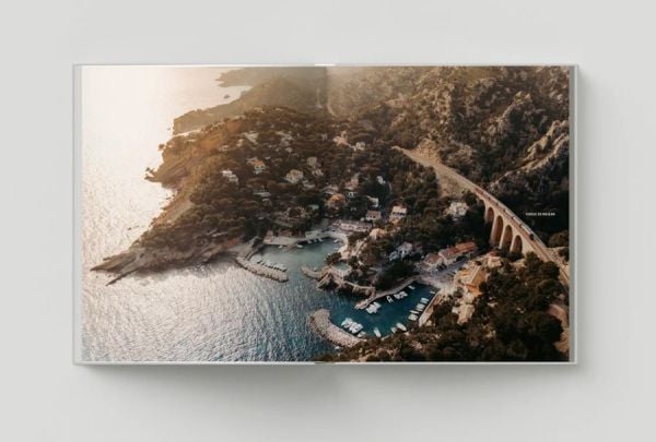 Book cover of Follow the Coast – from Gibraltar to Monaco: The Mediterranean Coast; featuring a scenic coastal view of rugged cliffs and calm waters. Published by Lannoo Publishers.
