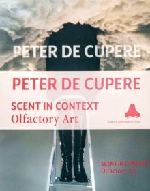 Book cover of Peter de Cupere: Scent in Context: Olfactory Art, with a figure standing on a step ladder, upper torso obscured by smoke. Published by Hopper&Fuchs.