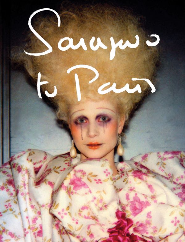 Book cover of Sarajevo to Paris: Marleen Daniëls, with a fashion model with bouffant hair, wearing a large floral garment. Published Hopper&Fuchs.