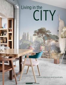 Interior dining space, landscape mural on wall, industrial silver flue in corner, on cover of 'Living in the City, Urban Interiors and Portraits', by Lannoo Publishers.