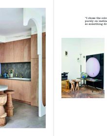 Interior dining space, landscape mural on wall, industrial silver flue in corner, on cover of 'Living in the City, Urban Interiors and Portraits', by Lannoo Publishers.