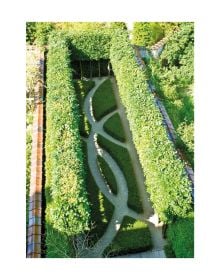 Large green topiary balls edging grass area, with 2 wooden benches, THE WIRTZ GARDENS in white font right of centre