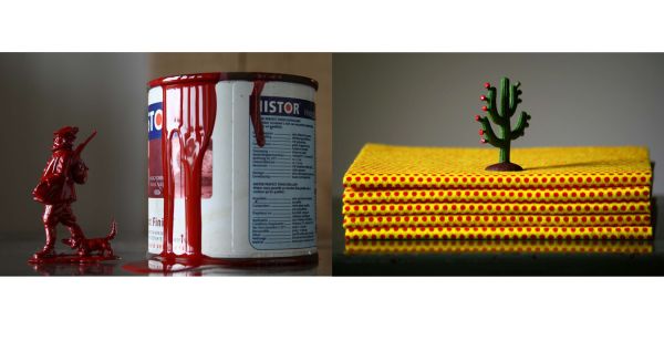 Book cover of Saskia Boelsums. Artist with a Camera, featuring a shiny red pomegranate on white table cloth. Published by Lannoo Publishers.