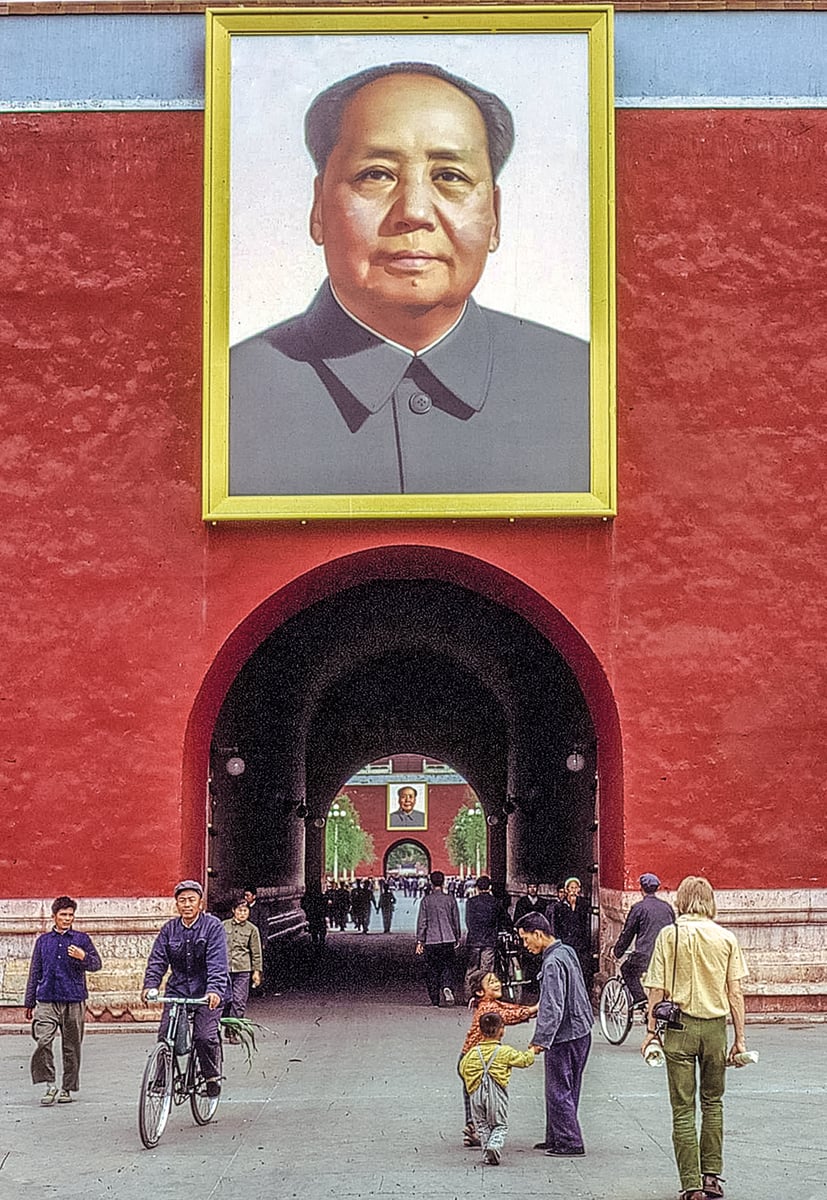 Elderly Chinese man in navy slacks walking through street, Seen Through a Photographers Eyes CHINA in gold font on left red banner.