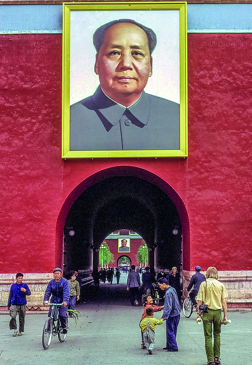 An older Chinese man in navy slacks walking through street, on landscape cover of 'China, Seen Through a Photographers Eyes', by Booxencounters.