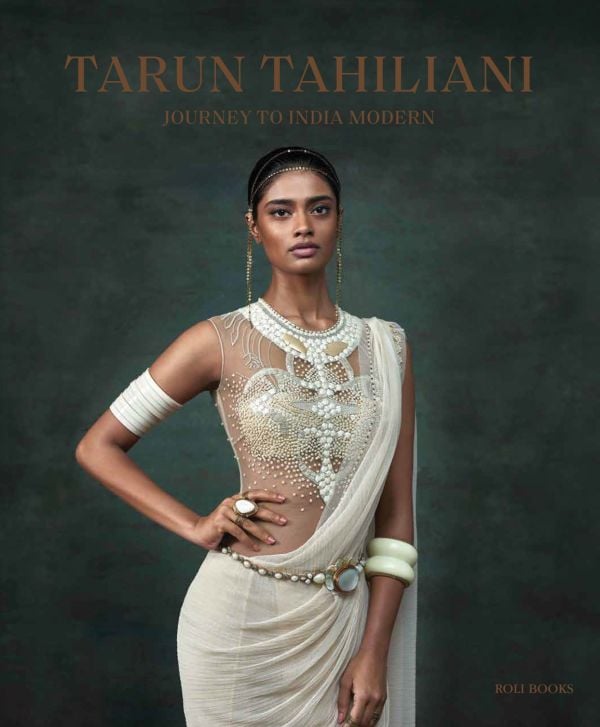 Book cover of Tarun Tahiliani: Journey to India Modern, with a model in white dress with beaded bodice. Published by Roli Books.