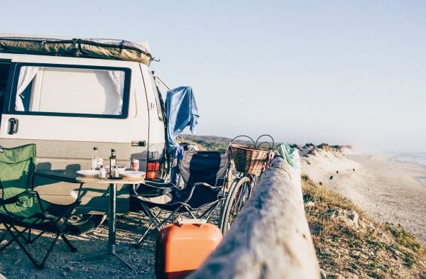 Book cover of Van Life: Culture, Vehicles, People, Places, with white and green camper van parked by the seaside, figure looking out to sea. Published by Lannoo Publishers.