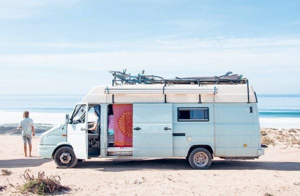 Book cover of Van Life: Culture, Vehicles, People, Places, with white and green camper van parked by the seaside, figure looking out to sea. Published by Lannoo Publishers.