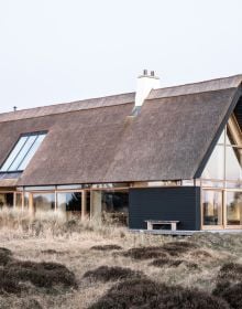 Book cover of Nordic Homes: Scandinavian Architecture Immersed in Nature, with a long residential home with large windows. Published by Lannoo Publishers.