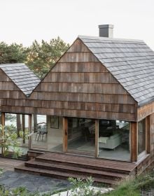 Book cover of Nordic Homes: Scandinavian Architecture Immersed in Nature, with a long residential home with large windows. Published by Lannoo Publishers.