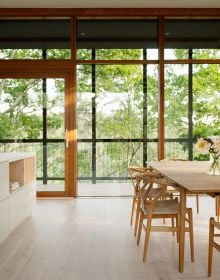 Book cover of Nordic Homes: Scandinavian Architecture Immersed in Nature, with a long residential home with large windows. Published by Lannoo Publishers.