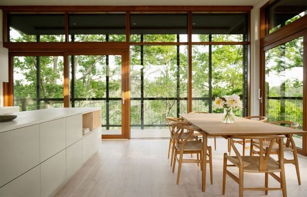 Book cover of Nordic Homes: Scandinavian Architecture Immersed in Nature, with a long residential home with large windows. Published by Lannoo Publishers.