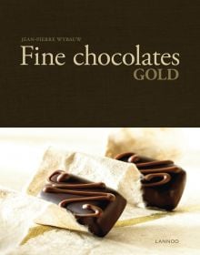 Book cover of Fine Chocolates: Gold; with two luxury chocolates with caramel swirls on top. Published by Lannoo Publishers.