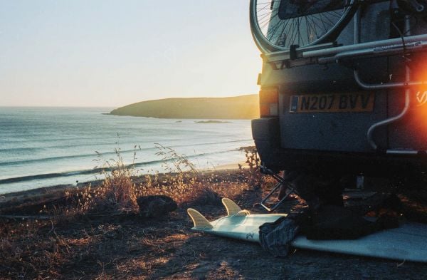 Book cover of Build a Campervan: The Definitive Guide, featuring an aerial view of a campervan with its contents laid out on the grass. Published by Lannoo Publishers.