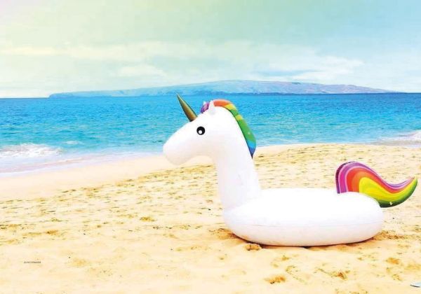 White Llama with blue unicorn horn on head, on pale yellow cover of 'Insta Grammar: Unicorn', by Lannoo Publishers.