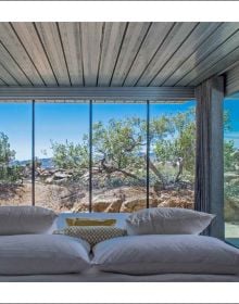 Modern, luxury cabin on remote Norwegian island, covered in snow, on cover of 'Nature View, The Perfect Holiday Homes', by Lannoo Publishers.
