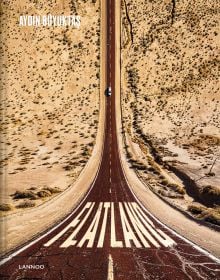 Aerial view of car on road driving through desert, on cover of 'Flatland', by Lannoo Publishers.