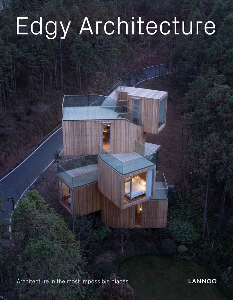 Modern wood stacked structure in forest, near winding road, Edgy Architecture in white font above by Lannoo Publishers.