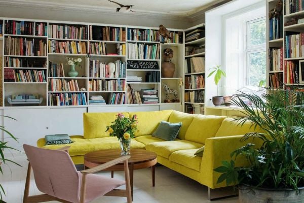 Book cover of Nordic Moods: A Guide to Successful Interior Decoration, featuring a minimalist dining interior, table and chairs, low light fixing, white walls. Published by Lannoo Publishers.
