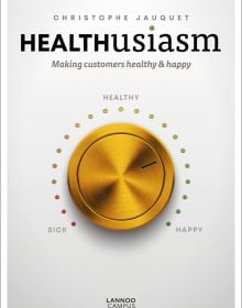 Gold control dial labelled 'sick', 'healthy', 'happy', on white cover of 'Healthusiasm, Making Customers Healthy & Happy', by Lannoo Publishers.
