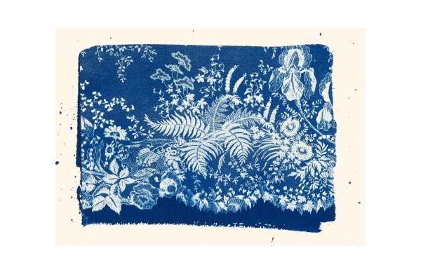 Black and white shot of a negligee with mustard filter over half of image, on cover of 'Garden of Lace, Carine Gilson', by Lannoo Publishers.