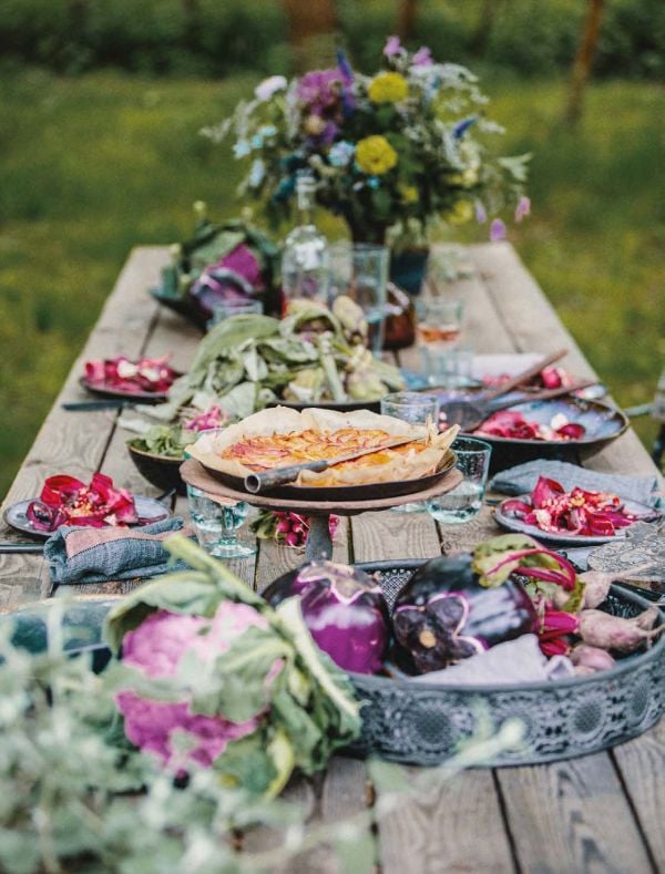 Plate of fish cakes on bed of green cabbage, pot of utensils to side, on cover of 'Low Carb Cookbook with 4 Ingredients 2, by Lannoo Publishers.