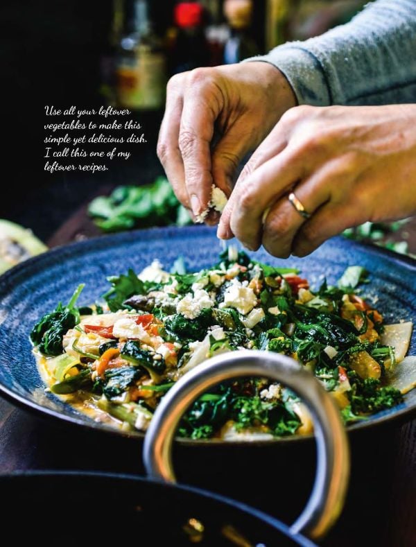 Plate of fish cakes on bed of green cabbage, pot of utensils to side, on cover of 'Low Carb Cookbook with 4 Ingredients 2, by Lannoo Publishers.