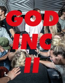 Group of people at religious convention, placing hands on each others backs, on cover of 'God Inc I & II', by Lannoo Publishers.