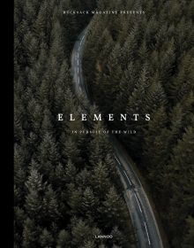 Aerial shot of road winding through green forest trees, on cover of 'Elements, In Pursuit of the Wild', by Lannoo Publishers.