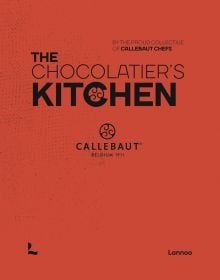 Orange book cover of 'The Chocolatier’s Kitchen, recipe book', by Lannoo Publishers.