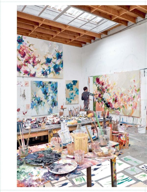 Abstract painting with salmon pink backdrop and dark blue, maroon and yellow floral shapes, on cover of 'Arne Quinze', by Lannoo Publishers.