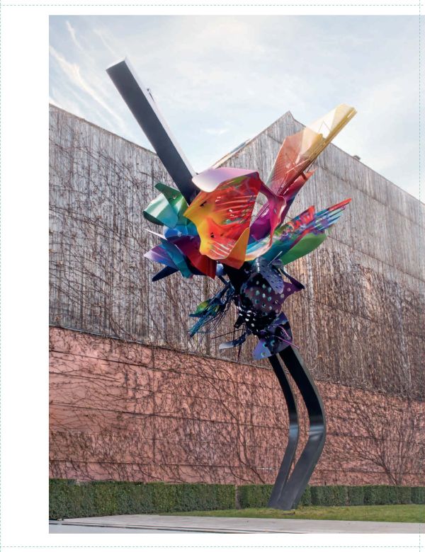 Abstract painting with salmon pink backdrop and dark blue, maroon and yellow floral shapes, on cover of 'Arne Quinze', by Lannoo Publishers.