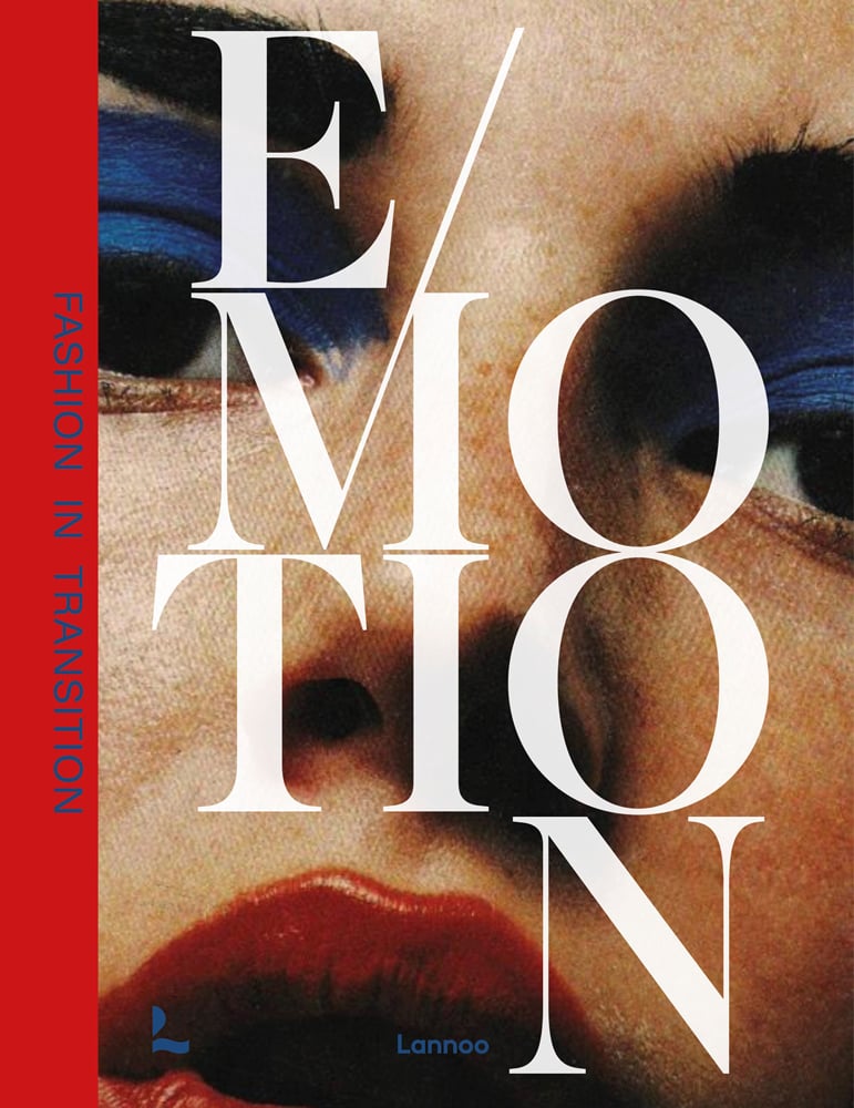 Close up shot of fashion model with bright blue eyeshadow and red lipstick with Emotion in large white font across cover