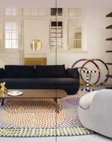 Living interior with navy wall panelling, large black and white rug, arch windows, on cover of 'Carpets & Rugs, Every home needs a soft spot', by Lannoo Publishers.