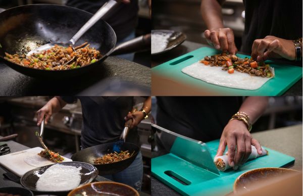 Book cover of The Thai Kitchen of Boo Raan, Sharing Recipes From Dokkoon Kapueak, with an Asian style chicken dish in restaurant kitchen, with chef topping with herbs. Published by Lannoo Publishers.