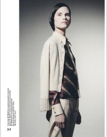 Torso of model in white shirt and trousers with large horseshoe around neck, on cover of 'Brussels Touch', by Lannoo Publishers.