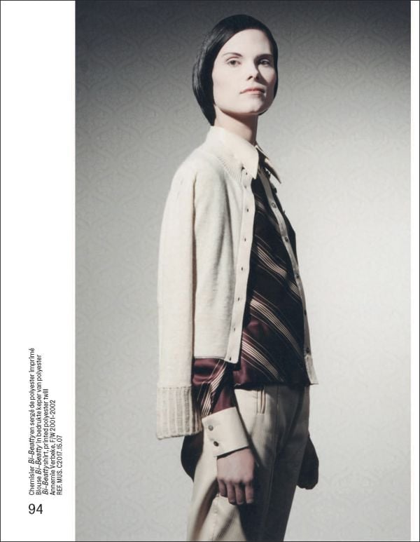 Torso of model in white shirt and trousers with large horseshoe around neck, on cover of 'Brussels Touch', by Lannoo Publishers.