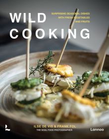 Plate of small green and yellow stacked canapes, on cover of 'Wild Cooking, Surprising Seasonal Dishes With Fresh Vegetables and Fruits', by Lannoo Publishers.