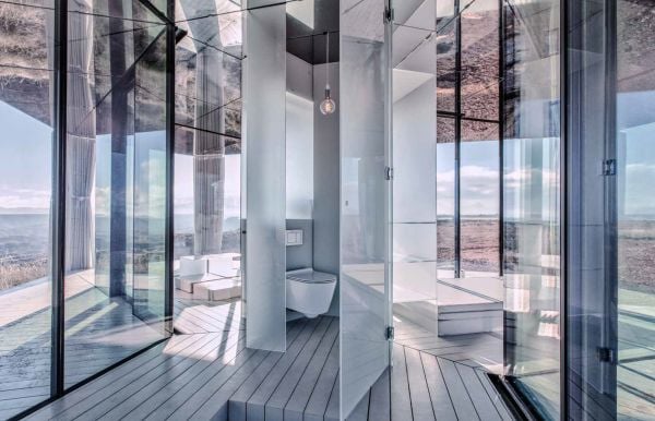 Book cover of Hidden Architecture, Buildings that Blend In, with a house surrounded by carved rock. by Lannoo Publishers