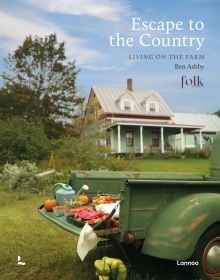 Old American farm truck, fresh fruit and vegetables on a tray with watering can resting on back door, on cover of 'Escape to the Country', by Lannoo Publishers.