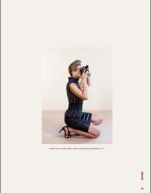 Book cover of Eli Rezkallah, Life in Plastik, with a model in pink tunic and hat, standing behind shelves of pink plastic product bottles. Published by Lannoo Publishers.