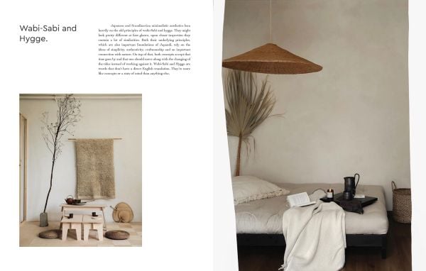 Book cover of Japandi Living, Japanese Tradition. Scandinavian Design, with a calm, interior living space with pale wood table and chairs, low light fixture, and white sofa. Published by Lannoo Publishers.