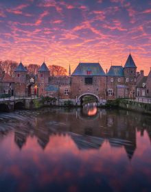 Book cover of The Beauty of the Netherlands: 10 Years of Photography by Albert Dros, with an aerial shot of an atmospheric landscape with windmills. Published by Lannoo Publishers.