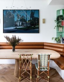 Book cover of London Interiors, featuring an interior living room with high ceiling, green walls, a blue velvet chair, and fireplace. Published by Lannoo Publishers.
