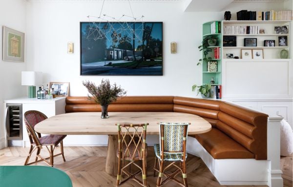 Book cover of London Interiors, featuring an interior living room with high ceiling, green walls, a blue velvet chair, and fireplace. Published by Lannoo Publishers.