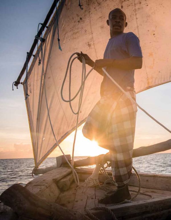 Book cover of Off-Grid Adventures: 20 Untamed Travel Stories Around the World, with a rider on horseback in remote mountain landscape, with dog walking beside. Published by Lannoo Publishers.