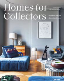 Interior living space with bronze figure on coffee table, framed portrait sketch on wall, on cover of 'Homes for Collectors', by Lannoo Publishers.