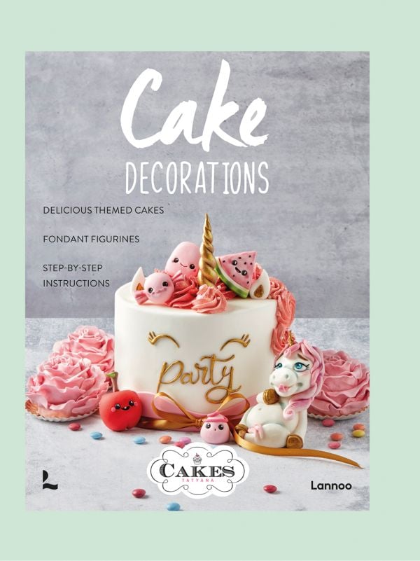 Book cover of Cake Decorations, with a single tiered cake covered in white fondant, and 'Party' in gold writing, with gold unicorn horn on top. Published by Lannoo Publishers.