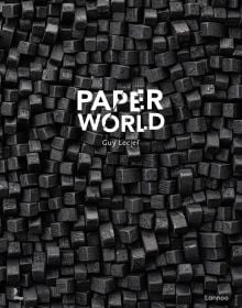 Black cubes of recycled cardboard resembling small charcoal briquettes, on cover of 'Paperworld ', by Lannoo Publishers.