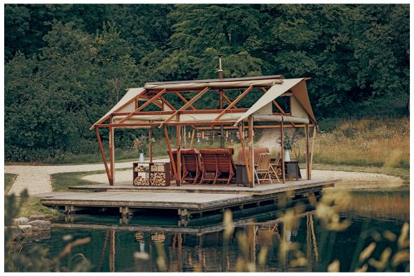 Book cover of Outdoor Interiors, with an outside seating area of Tehama 1 House in California, with fireplace. Published by Lannoo Publishers.